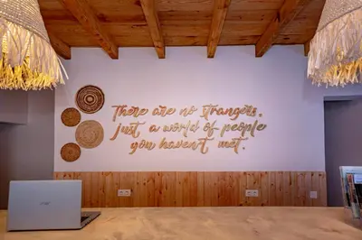 a wall with a writing on the wall with a laptop at Sun Lovers Hostel in Albufeira