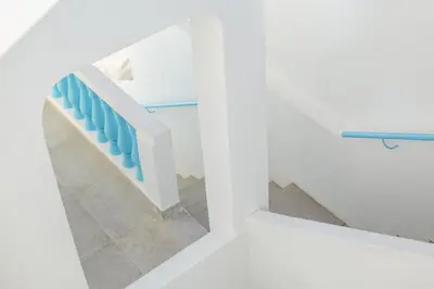 a staircase with blue railings in a white house at Sun Lovers Hostel in Albufeira