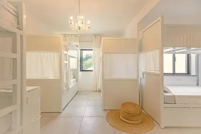 a bedroom with bunk beds and a hat on the floor at Sun Lovers Hostel in Albufeira