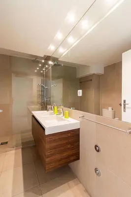 a bathroom with a sink and a large mirror at BmyGuest - Vilamoura Marina's View in Vilamoura