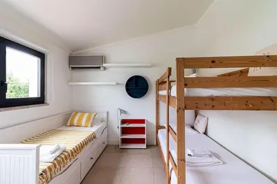 a bedroom with two bunk beds and a window at BmyGuest - Vilamoura Marina's View in Vilamoura