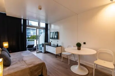 a bedroom with a bed and a table in a room at BmyGuest - Oura Beach Studio I in Albufeira