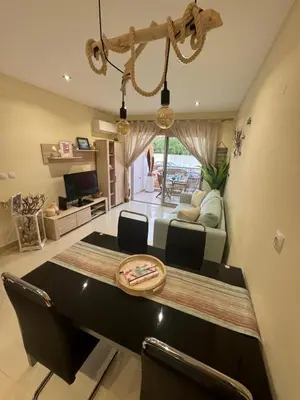 a living room with a dining table and a couch at Lendas de Portugal in Olhos de Água