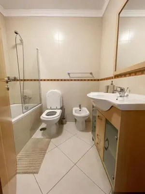 a bathroom with a toilet and a sink and a shower at Vitamin Sea Vilamoura in Quarteira