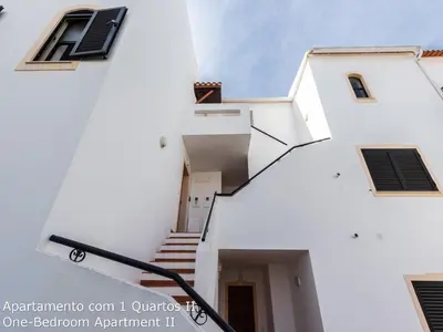 a stairway leading up to a white building at Akisol Albufeira Sunny in Roja- Pé