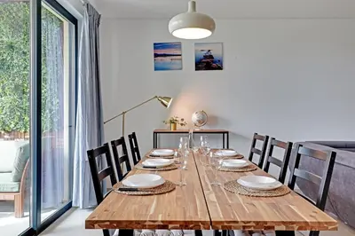 a dining room with a wooden table and chairs at Andiamo Apartment in Vilamoura