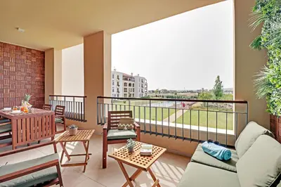 a balcony with a couch and chairs and a table at Andiamo Apartment in Vilamoura