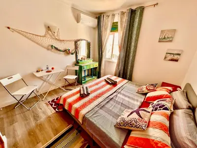 a bedroom with a bed and a table and a window at City Dacha - Ocean in Albufeira