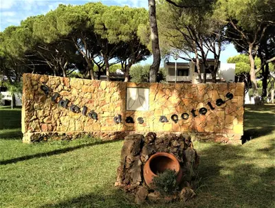 a sign that says apache on a stone wall at Casinha nas Açoteias in Olhos de Água