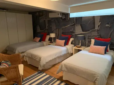 a room with three beds with pillows on them at Casa de Férias com piscina - Condominio Vilamouraténis in Vilamoura