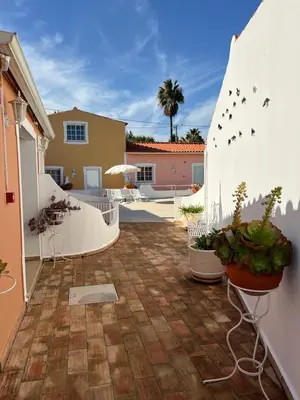a kitchen with a white table and white chairs at SOLAR DOS AVÓS in Guia