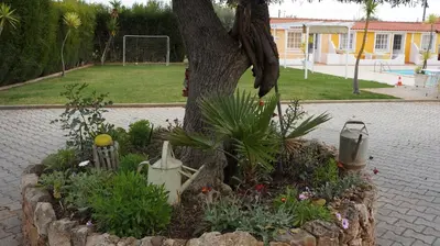 a brick fireplace in a yard with trees at SOLAR DOS AVÓS in Guia