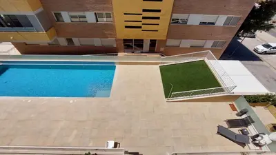 an overhead view of a swimming pool in front of a building at Forte Novo Beach in Quarteira