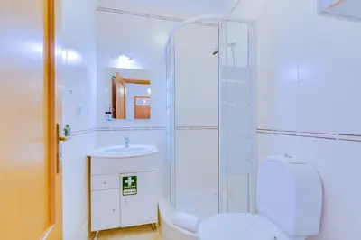 a bathroom with a shower and a toilet and a sink at AL - Quarteira Old Town in Quarteira