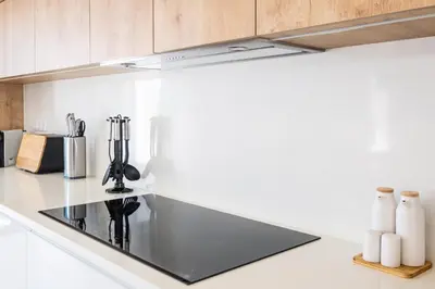 a kitchen with a black stove top in a kitchen at Atlantis Luxury Villa by Atlantic Places in Albufeira