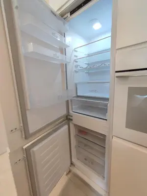 a white refrigerator with its door open with its door open at Sonho Azul in Albufeira