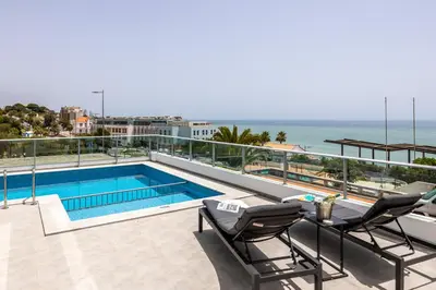 a balcony with a swimming pool and a view of the ocean at Casa Salty in Albufeira
