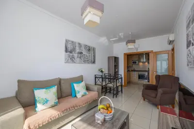 a living room with a couch and a table at Algarve Beach Apartments in Albufeira