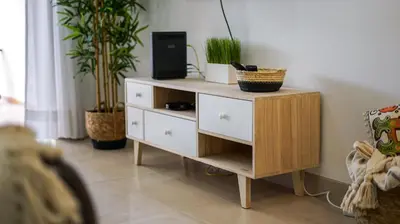 a wooden dresser with plants on it in a room at Açoteias B3 in Albufeira