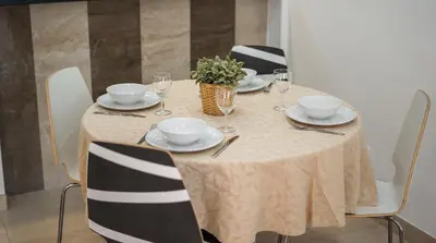 a table with plates and glasses and a plant on it at Açoteias B3 in Albufeira