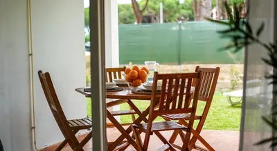 a table with two chairs and a bowl of fruit on it at Açoteias B3 in Albufeira