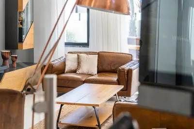 a living room with a couch and a table at Villa kambolé in Albufeira