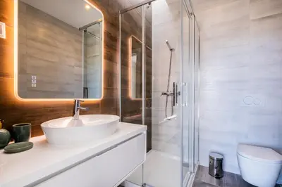a bathroom with a sink and a shower at Villa kambolé in Albufeira
