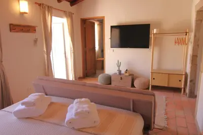 a bedroom with a bed and a television in it at Vila Lobo Algarve in Faro