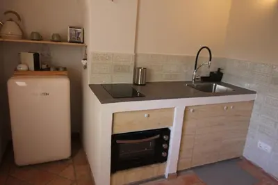 a small kitchen with a sink and a dishwasher at Vila Lobo Algarve in Faro