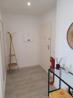a white room with a ladder and a glass table at Apartamento T1 Salgados in Guia