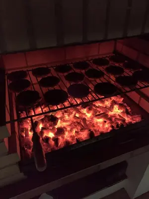 a fire in an oven with some food in it at Casa do Pomar by Portucasa in Alte