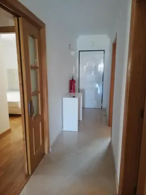 a hallway with a door and a room with a refrigerator at Villa V2 U in Olhos de Água