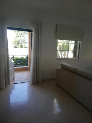 a living room with a couch and a large window at Villa V2 U in Olhos de Água