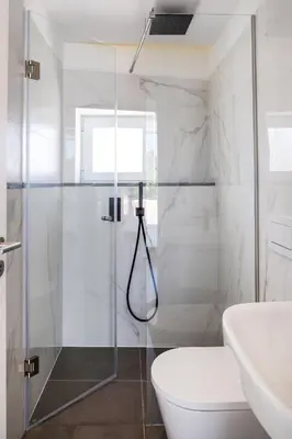 a bathroom with a shower and a toilet and a sink at Casa Monte dos Entrudos in Almancil