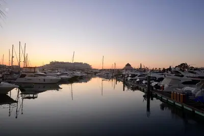 a group of boats docked in a marina at sunset at Villa Cove - Villa in complex only 5 minutes from the Marina of Vilamoura in Quarteira