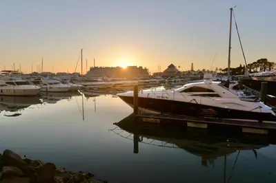a group of boats docked in a marina at sunset at Villa Cove - Villa in complex only 5 minutes from the Marina of Vilamoura in Quarteira