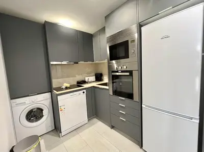 a kitchen with a washing machine and a washer at Miral 4 - 100 mtr to beach by HD PROPERTIES in Quarteira