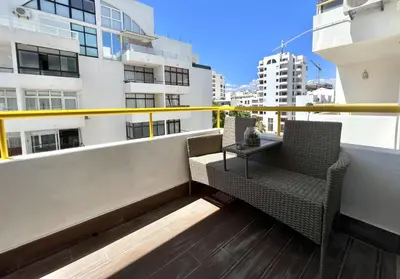 a balcony with two chairs and a table on a building at Miral 4 - 100 mtr to beach by HD PROPERTIES in Quarteira