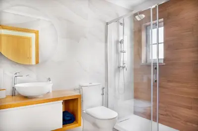 an empty hallway with wooden doors and a toilet at Apartamento no Condomínio Baia Village com Piscina in Albufeira