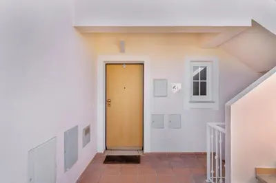 a hallway with a brown door in a building at Apartamento no Condomínio Baia Village com Piscina in Albufeira