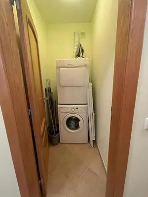 a laundry room with a washing machine and a washer at Lovely 2 Bedroom Home inside a Resort in Albufeira in Albufeira
