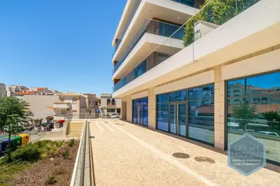 a building with a sign that reads open lookup at Albufeira Prime 1B - Dream Lodging in Albufeira