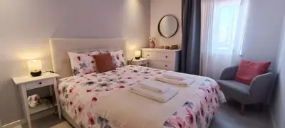 a small bedroom with a bed and a chair at 209 Modern Apartment in central Albufeira close to everything in Albufeira