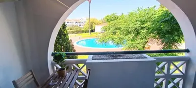 a balcony with a view of a swimming pool at 209 Modern Apartment in central Albufeira close to everything in Albufeira
