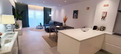 a kitchen and living room with a couch and a table at 209 Modern Apartment in central Albufeira close to everything in Albufeira