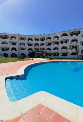 an empty swimming pool in front of a building at 209 Modern Apartment in central Albufeira close to everything in Albufeira