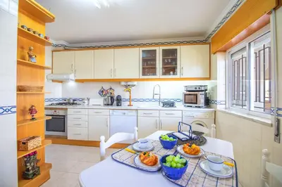 a kitchen with a table with fruit on it at Apartamento Varandas do Sol in Vilamoura