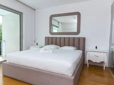 a bedroom with a large white bed with a mirror at Harmony 4I House by Stay ici Algarve Holiday Rental in Albufeira
