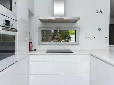 a kitchen with white cabinets and a window at Harmony 4I House by Stay ici Algarve Holiday Rental in Albufeira