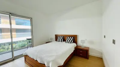a bedroom with a bed and a large window at Prime by Check-in Portugal in Albufeira